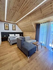 a living room with a couch and a bed at Old Mill Heritage Hotel in Ndërlysaj