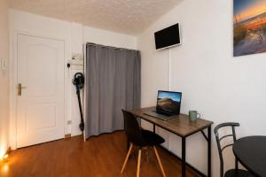 a room with a desk with a laptop computer on it at Marans in Marans