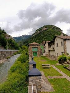 a building on the side of a river with houses at Iguzki Etxea in Urzainqui