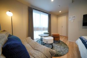 a living room with a couch and a table at LinksHotel 西荻窪 in Ogikubo +74 photos