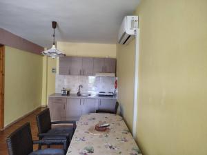 a kitchen with a table and chairs and a kitchen with a table and chairsktop at Thomas Vrasna Close To The Sea in Nea Vrasna
