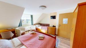 a hotel room with a bed and a desk at Goldener Engel /Pension in Görlitz