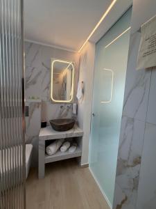 a bathroom with a sink and a mirror at Afroditi Syros in Ermoupoli