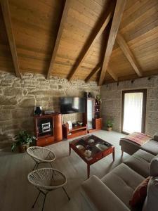 a living room with a couch and a table at As Fontaiñas in Beiro
