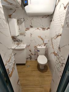 a bathroom with a toilet and a sink at Guesthouse Flora in Kiten +121 photos