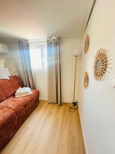 a living room with a couch and a window at Aytré plage in Aytré