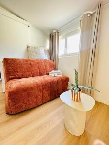 a living room with a couch and a table at Aytré plage in Aytré