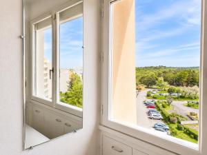 a window with a view of a parking lot at Studio - Marina 4 - 17 allée des Pinons - 5-1 in Saint-Jean-de-Monts