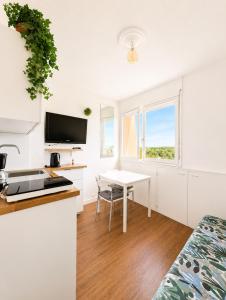 a kitchen and dining room with a table and a window at Studio - Marina 4 - 17 allée des Pinons - 5-1 in Saint-Jean-de-Monts
