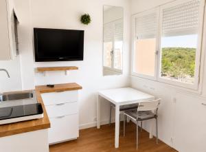 a kitchen with a white desk and a tv at Studio - Marina 4 - 17 allée des Pinons - 5-1 in Saint-Jean-de-Monts