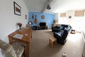 a living room with a couch and a table at Sailor's Rest in Anstruther