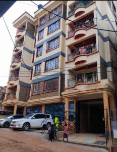 a group of people standing outside of a building at Nadine's Enclave in Kisii