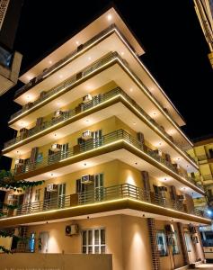 a large apartment building with balconies at night at Cloud Bay Hotels - Sector 69 in Gurgaon