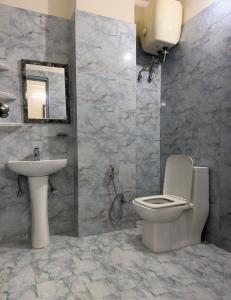 a bathroom with a toilet and a sink at Cloud Bay Hotels - Sector 69 in Gurgaon +20 photos
