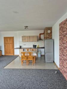 a kitchen with a table and chairs and a refrigerator at Villa Hillas in Reda
