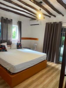 a bedroom with a large bed in a room at One Love Garden Villas Paje in Kiganga +48 photos
