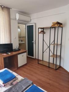 a room with a bedroom with a desk and a mirror at Guest house Villa Stefi in Sozopol +52 photos