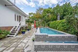 a swimming pool in the backyard of a house at 8 Sleeper, 4 Bedroom Home in Franschhoek in Franschhoek