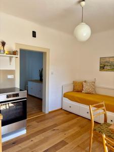 a living room with a bed and a kitchen at Domek u vína in Perná +34 photos