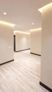 an empty room with white walls and wooden floors at Hotel RADOJA in Shkodër +4 photos