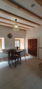 a dining room with a wooden table and chairs at Duplex de l'abbaye in Pébrac