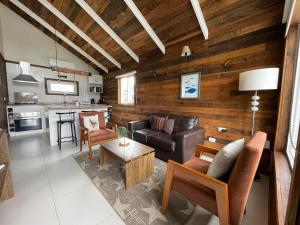 a living room with a couch and a table at Cabañas Laguna Magica in Valdivia