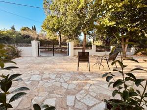 a patio with a table and chairs and a fence at Seaside Garden House 7 in Dassia