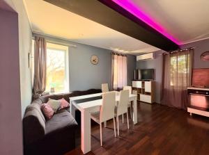 a living room with a table and a couch at Guest House Devetaki in Devetaki