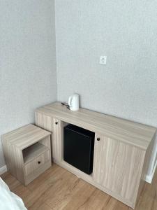 a wooden shelf with a microwave on top of it at Moskovskaya in Atyrau