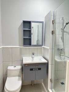 a bathroom with a toilet and a sink and a shower at Moskovskaya in Atyrau