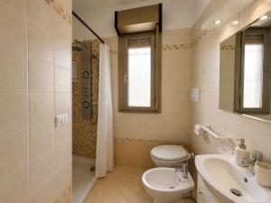 a bathroom with a toilet and a sink and a shower at Anthea - Timavo apartament 1 in Lignano Sabbiadoro