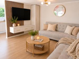a living room with a couch and a table at Lake House Mierzyn in Mierzyn