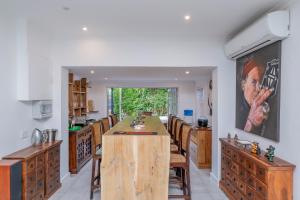 a kitchen with a large wooden island in the middle at 8 Sleeper, 4 Bedroom Home in Franschhoek in Franschhoek