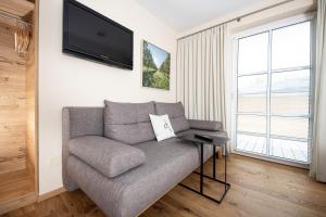 a living room with a couch and a flat screen tv at Genussgut Krispel in Neusetz