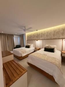 a hotel room with two beds and a room with at Nilka Hotel Boutique in Santa Bárbara de Samaná +47 photos