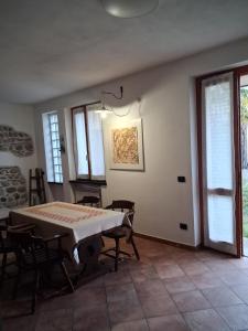 a dining room with a table and some windows at Il Borghetto in Castano Primo