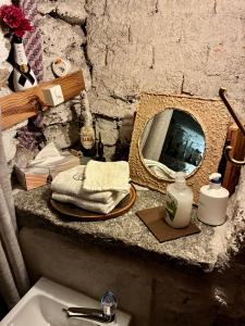 a bathroom with a sink and a mirror on a counter at THE OLD CELLAR no shower! in Locarno