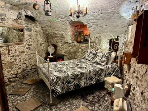 a bedroom with a bed in a stone wall at THE OLD CELLAR no shower! in Locarno
