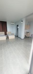 a large empty room with two beds in it at Hotel Datuna Aurum in Kobuleti