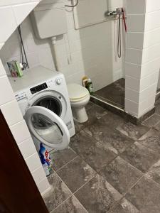 a bathroom with a washing machine and a toilet at jack hostel with private bathroom in Sremski Karlovci