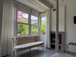 a living room with a couch in front of a window at Gule Cunda in Ayvalık
