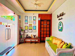 a living room with a green couch and a door at Casa Belina in Puerto Princesa City
