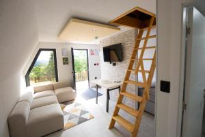 a living room with a couch and a ladder at Kraljičini konaci in Doboj