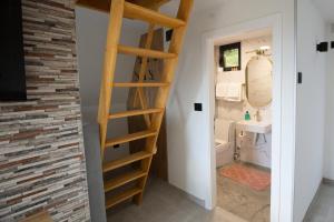 a bathroom with a ladder leading into a bathroom with a sink at Kraljičini konaci in Doboj +31 photos