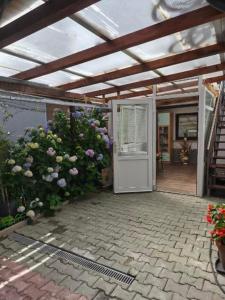 an open door to a house with flowers at Pri tetki 2 in Kranj