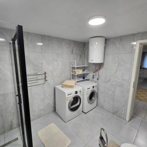 a laundry room with a washing machine and a washer at Pri tetki 2 in Kranj +2 photos