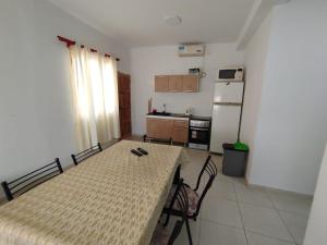 a small kitchen with a table and a refrigerator at Aprt Belgrano 658 in Neuquén