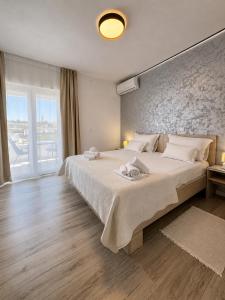 a bedroom with a large bed and a large window at Paulina Harmony Rooms in Seget Vranjica +76 photos