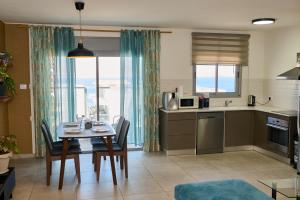 a kitchen and dining room with a table and chairs at Dream house in Eilat