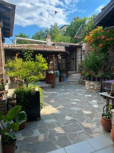 a stone patio in front of a house at Guest House Iljesa in Berat